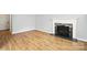 Bright living room with hardwood floors and a decorative fireplace at 5947 Quail Hollow Rd # A, Charlotte, NC 28210