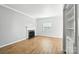 Bright living room with hardwood floors, a decorative fireplace, and ample natural light at 5947 Quail Hollow Rd # A, Charlotte, NC 28210