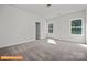 Bright bedroom with neutral carpeting and a view to the outdoors through two sunny windows at 6328 Busch Way, Midland, NC 28107