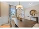 Dining area featuring a large table, chandelier, and patterned curtains by a window at 6328 Busch Way, Midland, NC 28107