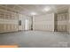 Spacious unfinished garage with concrete floors and ample room for storage and parking at 6328 Busch Way, Midland, NC 28107