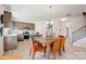 Open-concept kitchen and dining area with stainless steel appliances and a breakfast bar at 6328 Busch Way, Midland, NC 28107