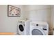 Modern laundry room with a front-load washer and dryer and a wire shelf for storage at 6328 Busch Way, Midland, NC 28107