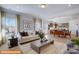 Bright living room seamlessly connects to dining area, creating an inviting and open floor plan at 6328 Busch Way, Midland, NC 28107