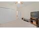 Bright bedroom features neutral carpet, ceiling fan, closet and a doorway leading to another room at 7189 Bovine Ln # 28, Harrisburg, NC 28075