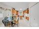 Open kitchen and dining area featuring wooden cabinets and plenty of counter space at 7189 Bovine Ln # 28, Harrisburg, NC 28075
