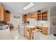 Bright kitchen featuring wooden cabinetry and modern appliances at 7189 Bovine Ln # 28, Harrisburg, NC 28075