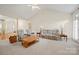 Large living room with vaulted ceilings, plush carpeting, neutral decor, and ample seating at 7189 Bovine Ln # 28, Harrisburg, NC 28075