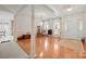 Open living room with gleaming hardwood floors, marble columns, and bright natural lighting that exudes a bright and spacious feel at 7189 Bovine Ln # 28, Harrisburg, NC 28075