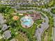 Community aerial view showcasing pool with slides, playground, clubhouse, volleyball court, and parking at 7339 Millstone Sw Cir, Concord, NC 28025