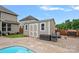Backyard features a shed with a concrete patio, outdoor seating and a partially visible pool for summer enjoyment at 7339 Millstone Sw Cir, Concord, NC 28025