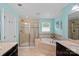 Bright bathroom featuring double vanity, a soaking tub and a glass shower at 7339 Millstone Sw Cir, Concord, NC 28025
