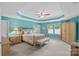 Main bedroom featuring a tray ceiling, ceiling fan, and large windows at 7339 Millstone Sw Cir, Concord, NC 28025