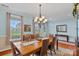 Elegant dining room featuring hardwood floors, a large table with seating for six, and large windows at 7339 Millstone Sw Cir, Concord, NC 28025