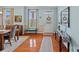 Inviting home entryway with hardwood floors, soft blue walls, a decorative rug, and ample natural light at 7339 Millstone Sw Cir, Concord, NC 28025
