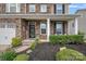 Close-up of a home's welcoming front porch with stone accents, manicured landscaping, and covered entry at 7339 Millstone Sw Cir, Concord, NC 28025