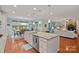 Open kitchen view to dining area and living room with stone fireplace at 7339 Millstone Sw Cir, Concord, NC 28025