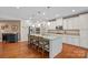 Kitchen with large island with bar seating, stainless appliances and white cabinets at 7339 Millstone Sw Cir, Concord, NC 28025