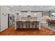 Spacious kitchen with gray cabinets, stainless steel appliances, hardwood floors, and granite countertops at 7339 Millstone Sw Cir, Concord, NC 28025