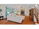 Comfortable living room with a stone fireplace, hardwood floors, bright windows, and comfortable seating at 7339 Millstone Sw Cir, Concord, NC 28025