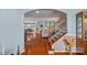 Open-concept living area with hardwood floors, a staircase, and views into the dining and living areas at 7339 Millstone Sw Cir, Concord, NC 28025