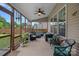 Screened porch with ceiling fan and comfortable seating with view of manicured backyard at 7339 Millstone Sw Cir, Concord, NC 28025
