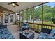 Relaxing screened porch with a view of the pool, lush landscaping, and backyard at 7339 Millstone Sw Cir, Concord, NC 28025