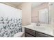 Clean bathroom features a single sink vanity with a floral shower curtain for a touch of elegance at 755 Lagan Ct, Fort Mill, SC 29715