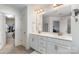 Bright bathroom with double sink vanity, tile floors, and a doorway leading to a walk-in closet at 755 Lagan Ct, Fort Mill, SC 29715