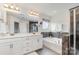 Luxurious bathroom featuring dual vanities, a soaking tub, and a separate glass-enclosed shower at 755 Lagan Ct, Fort Mill, SC 29715