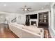 Elegant living room featuring a large sofa, fireplace with built-in shelving, and hardwood flooring at 755 Lagan Ct, Fort Mill, SC 29715