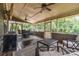 Relaxing screened porch features a ceiling fan, outdoor seating, and wooded views at 755 Lagan Ct, Fort Mill, SC 29715