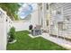 Serene backyard featuring lush green grass, white fencing, and an AC unit for comfortable outdoor living at 8108 Christmas Ct, Charlotte, NC 28216