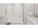 Clean, white bathroom featuring a tub/shower combination and marble vanity at 8108 Christmas Ct, Charlotte, NC 28216