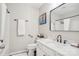 Well-lit bathroom featuring a framed mirror, white marble countertop, and modern fixtures for a comfortable experience at 8108 Christmas Ct, Charlotte, NC 28216