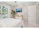 Bright bedroom with white comforter, ceiling fan, and a wall-mounted television at 8108 Christmas Ct, Charlotte, NC 28216