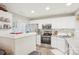 Bright kitchen boasts white cabinetry, stainless steel appliances, and granite countertops at 8108 Christmas Ct, Charlotte, NC 28216