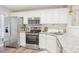 Clean, modern kitchen with white cabinets, stainless appliances and sink with luxury faucet at 8108 Christmas Ct, Charlotte, NC 28216