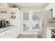 Well-lit kitchen with stainless steel refrigerator, granite countertops, and direct access to the backyard at 8108 Christmas Ct, Charlotte, NC 28216