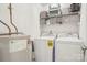Bright laundry area equipped with a modern washer, dryer, shelving, and essential equipment to simplify chores at 8108 Christmas Ct, Charlotte, NC 28216