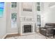 Comfortable living room featuring a fireplace, plenty of natural light, and cozy furnishings at 8108 Christmas Ct, Charlotte, NC 28216