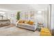 Comfortable living room featuring a plush sofa, elegant artwork, and ample natural light at 8108 Christmas Ct, Charlotte, NC 28216