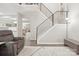 Bright living room featuring an open staircase and modern railings, flowing into the adjacent dining area at 8108 Christmas Ct, Charlotte, NC 28216