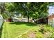 Spacious backyard with a well-manicured lawn, mature trees, and blooming flowers for a serene outdoor experience at 839 Montford Dr, Charlotte, NC 28209