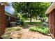 Lush backyard featuring a stone pathway, colorful hydrangeas, and mature trees, perfect for outdoor enjoyment at 839 Montford Dr, Charlotte, NC 28209