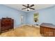 Cozy bedroom with soft blue walls, a ceiling fan, neutral carpet, and a window for natural light at 839 Montford Dr, Charlotte, NC 28209