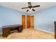 Bright, airy bedroom with light blue walls, neutral carpet, ceiling fan, and wood-paneled closet doors at 839 Montford Dr, Charlotte, NC 28209