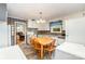 Bright eat-in kitchen featuring classic cabinets, tiled backsplash, and adjacent dining area at 839 Montford Dr, Charlotte, NC 28209
