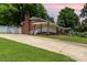 Exterior view of the brick home with a long driveway and well-maintained landscaping at 839 Montford Dr, Charlotte, NC 28209