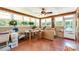 Bright sunroom filled with natural light, featuring a unique tiled floor and multiple windows with greenery at 839 Montford Dr, Charlotte, NC 28209